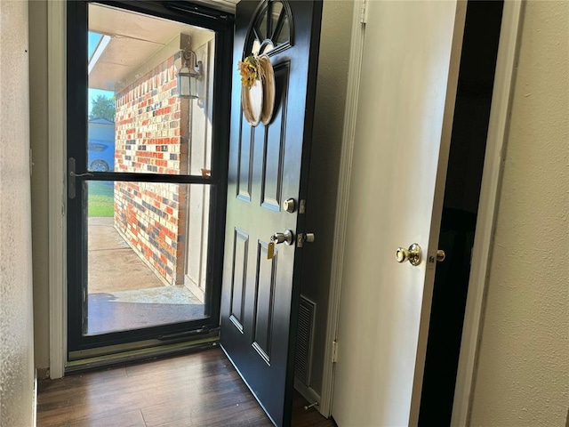 doorway with dark hardwood / wood-style floors