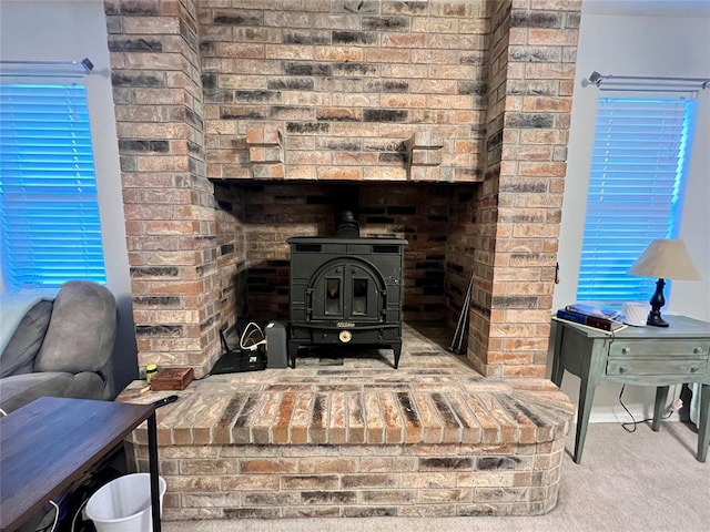 interior details with a wood stove and carpet floors