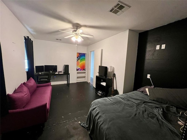 bedroom with ceiling fan and concrete flooring