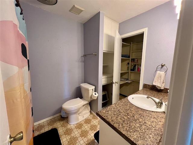 bathroom with tile patterned floors, vanity, and toilet