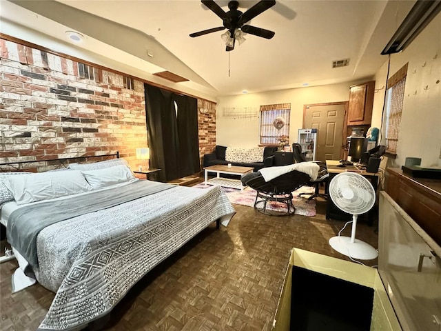 bedroom featuring dark parquet flooring, ceiling fan, lofted ceiling, and brick wall