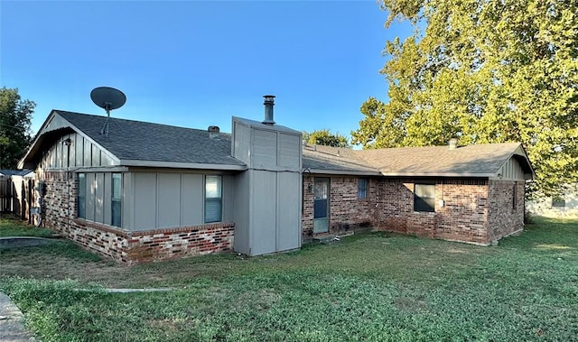 rear view of property with a yard