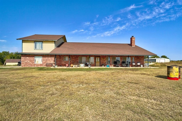 rear view of property featuring a yard