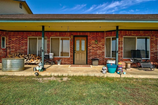 back of house with a yard and a patio