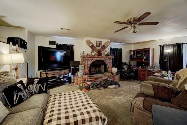 carpeted living room featuring ceiling fan and a fireplace