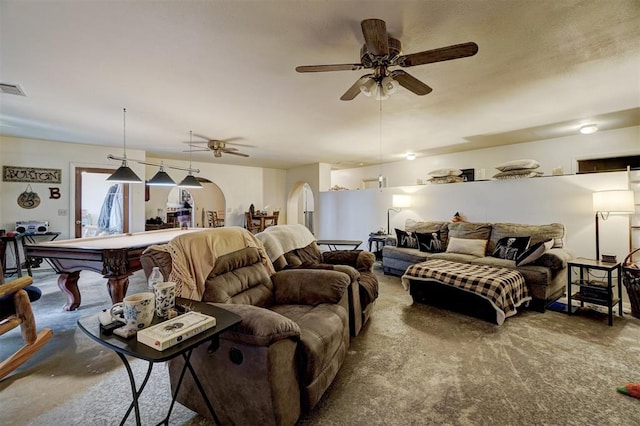 living room featuring concrete flooring, ceiling fan, and pool table