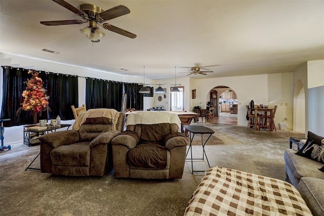 living room with ceiling fan and pool table