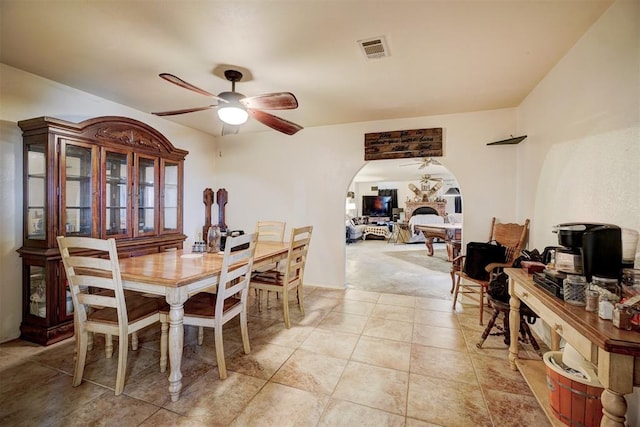 carpeted dining room featuring ceiling fan