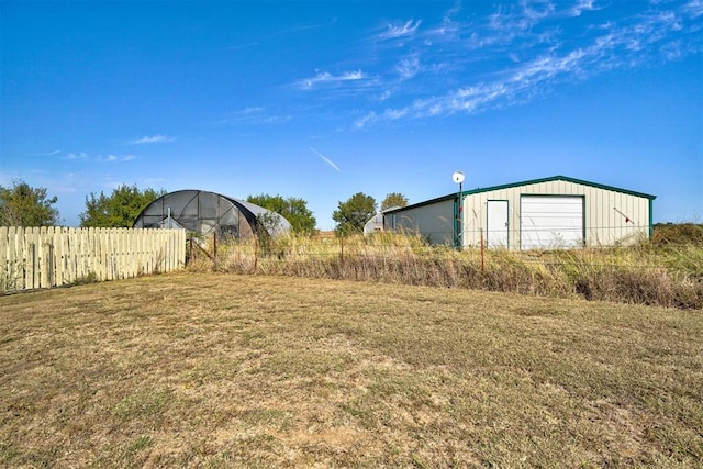 view of yard with an outdoor structure and a garage