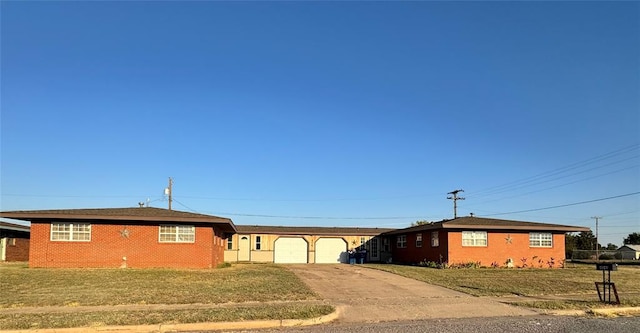 ranch-style house featuring a front yard and a garage