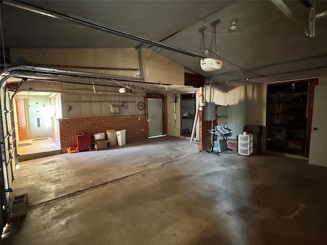 garage featuring electric panel and a garage door opener