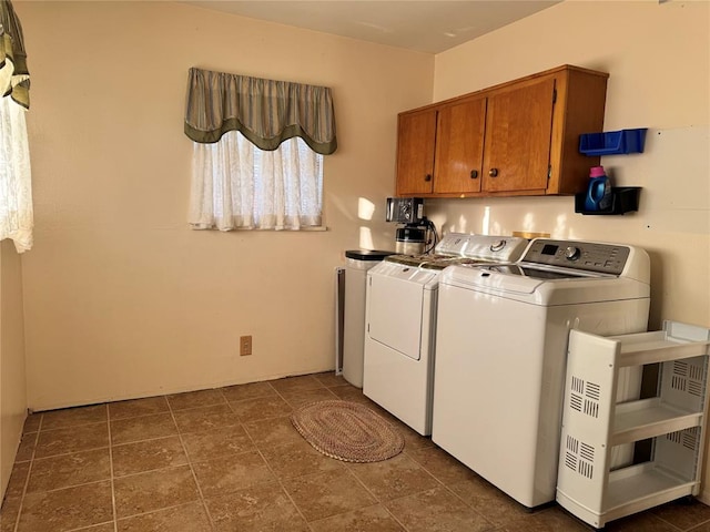 laundry area with cabinets and washing machine and dryer