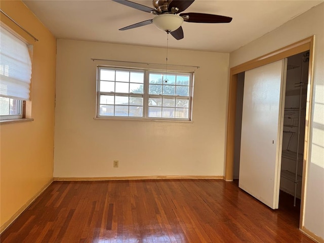 unfurnished bedroom featuring dark hardwood / wood-style floors, a closet, and ceiling fan