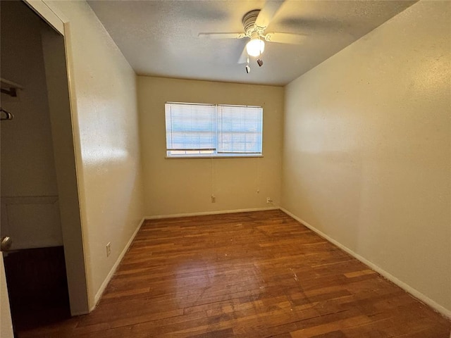 unfurnished bedroom with ceiling fan and dark hardwood / wood-style floors