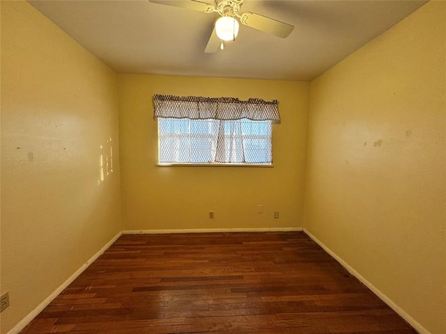 empty room with ceiling fan and dark wood-type flooring