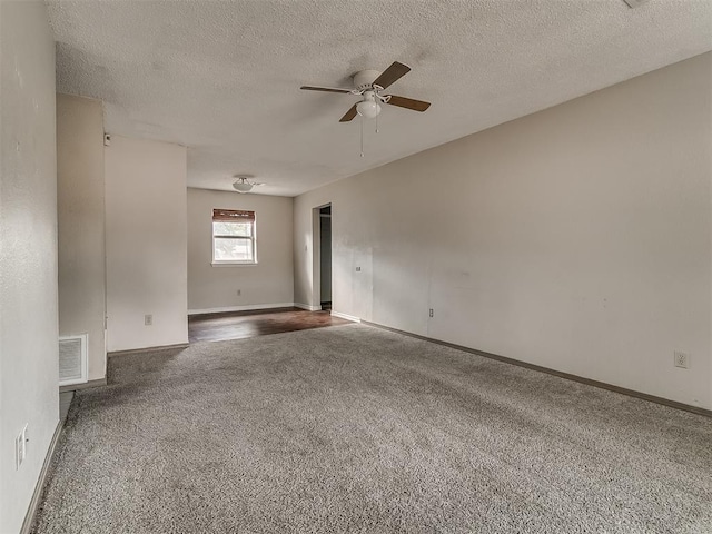 carpeted empty room with a textured ceiling and ceiling fan