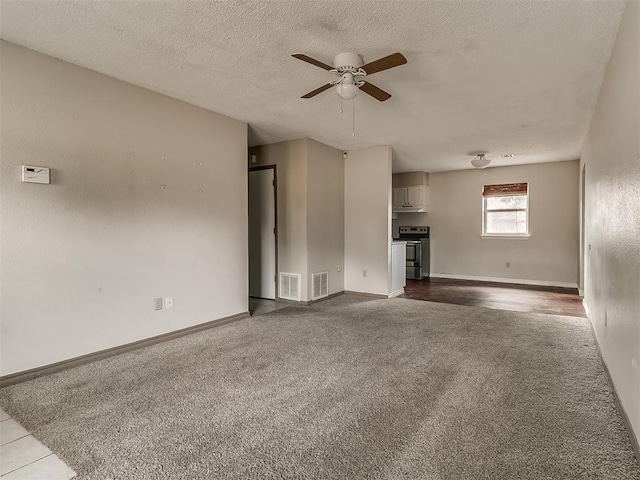 unfurnished living room with carpet flooring, ceiling fan, and a textured ceiling