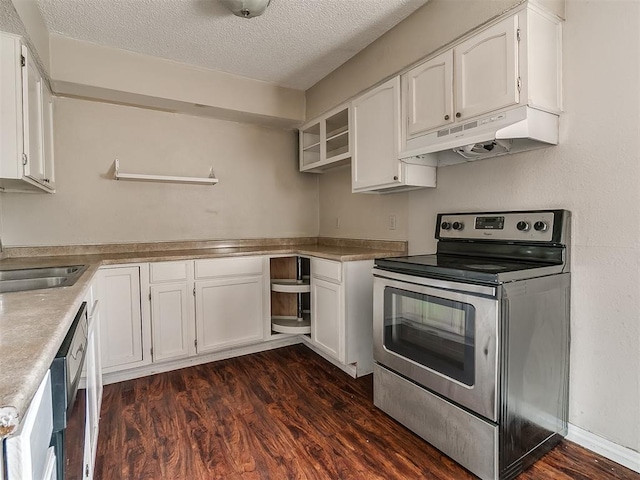 kitchen with appliances with stainless steel finishes, a textured ceiling, dark wood-type flooring, sink, and white cabinetry