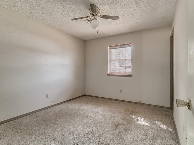 carpeted spare room featuring ceiling fan and a textured ceiling