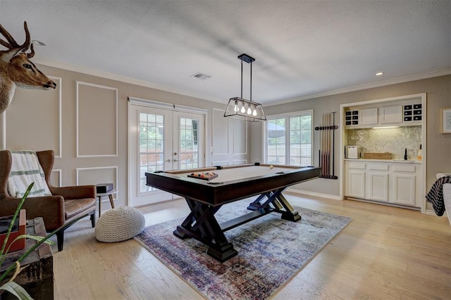 recreation room featuring light hardwood / wood-style floors, a wealth of natural light, and pool table