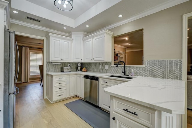 kitchen with light hardwood / wood-style floors, white cabinetry, sink, and appliances with stainless steel finishes