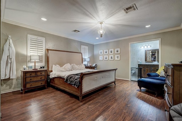 bedroom featuring a chandelier, ornamental molding, connected bathroom, and dark wood-type flooring