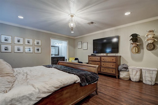 bedroom featuring dark hardwood / wood-style flooring, ornamental molding, and ensuite bath