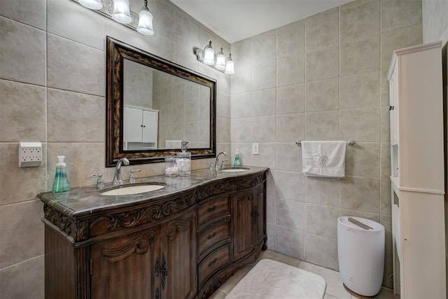 bathroom featuring tile patterned flooring, vanity, and tile walls