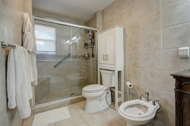 bathroom featuring tile patterned floors, a bidet, tile walls, and toilet