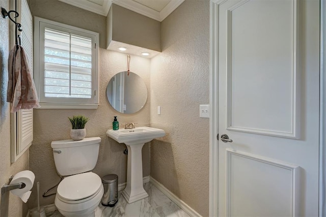 bathroom with crown molding and toilet