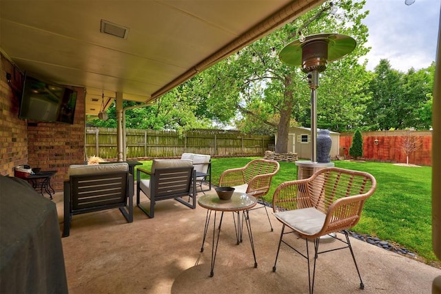 view of patio with an outdoor living space and a shed