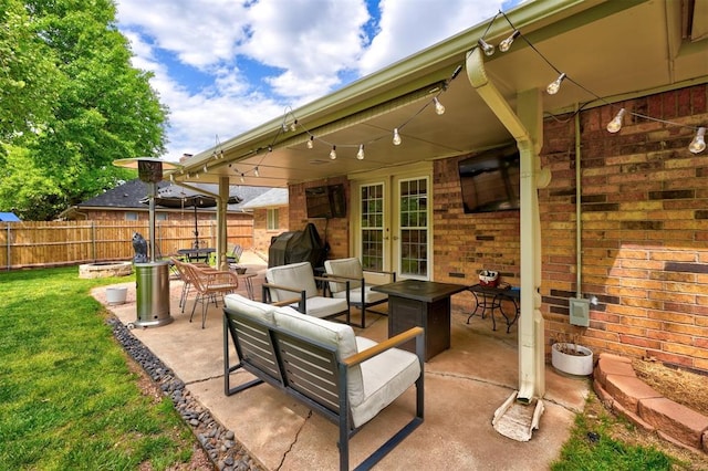 view of patio / terrace featuring french doors and an outdoor living space with a fire pit