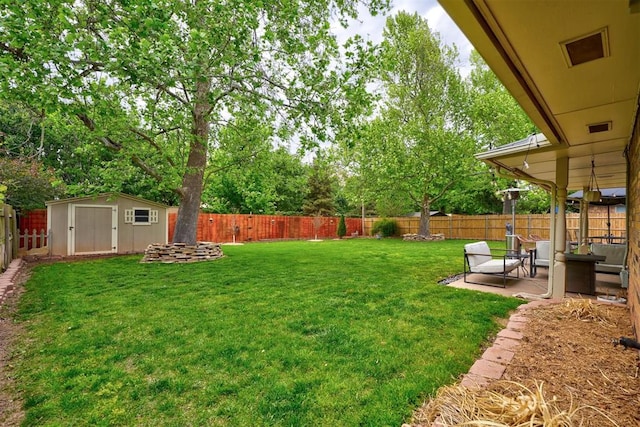 view of yard with a storage shed and a patio