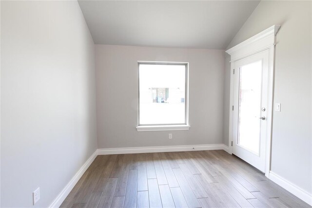 16025 Coneflower Dr, Edmond, OK 73013 - unfurnished room with wood finished floors, baseboards, and lofted ceiling