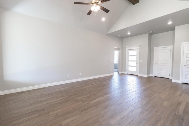 16025 Coneflower Dr, Edmond, OK 73013 - unfurnished living room featuring ceiling fan, high vaulted ceiling, beamed ceiling, baseboards, and wood finished floors