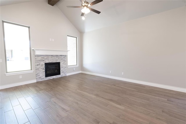 16025 Coneflower Dr, Edmond, OK 73013 - unfurnished living room with a ceiling fan, plenty of natural light, wood finished floors, beamed ceiling, and high vaulted ceiling