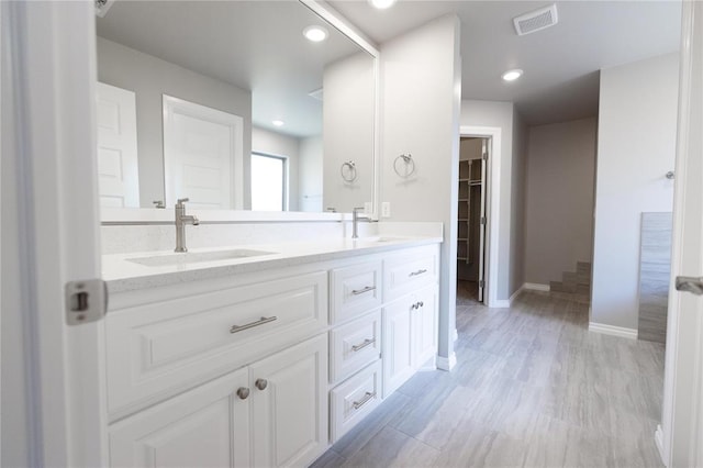 16025 Coneflower Dr, Edmond, OK 73013 - full bathroom featuring double vanity, baseboards, and a spacious closet