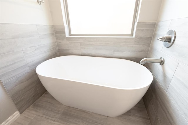 16025 Coneflower Dr, Edmond, OK 73013 - full bath with tile walls and a freestanding tub
