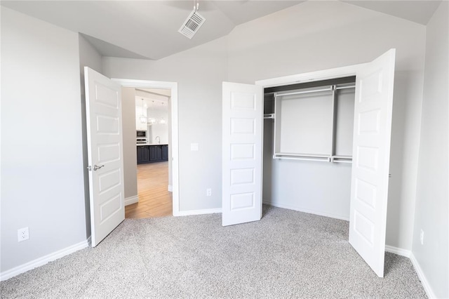 16025 Coneflower Dr, Edmond, OK 73013 - unfurnished bedroom featuring carpet floors, lofted ceiling, a closet, and baseboards