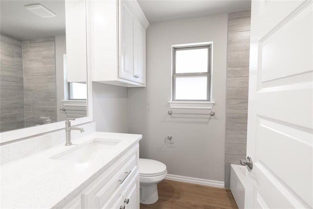 16025 Coneflower Dr, Edmond, OK 73013 - bathroom featuring toilet, vanity, wood finished floors, and baseboards