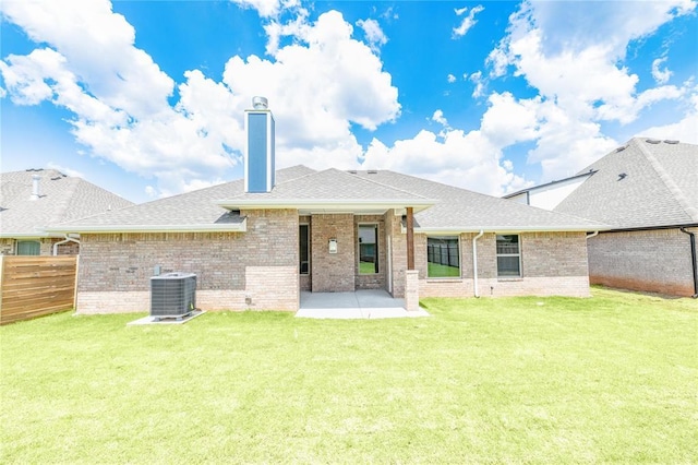 16025 Coneflower Dr, Edmond, OK 73013 - rear view of house with a chimney, brick siding, a patio, and cooling unit
