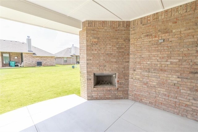 16025 Coneflower Dr, Edmond, OK 73013 - view of patio / terrace with an outdoor brick fireplace and central AC unit