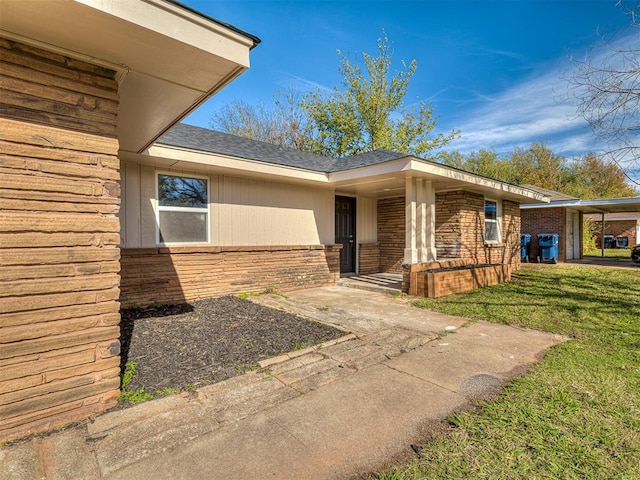 doorway to property featuring a yard