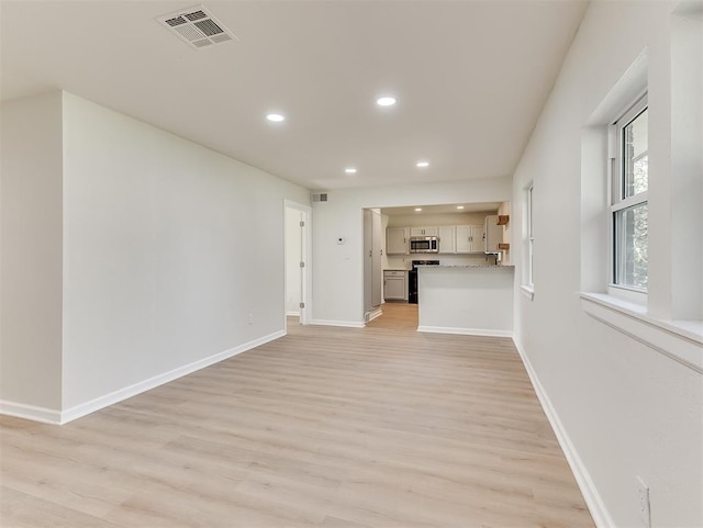 unfurnished living room featuring light hardwood / wood-style flooring