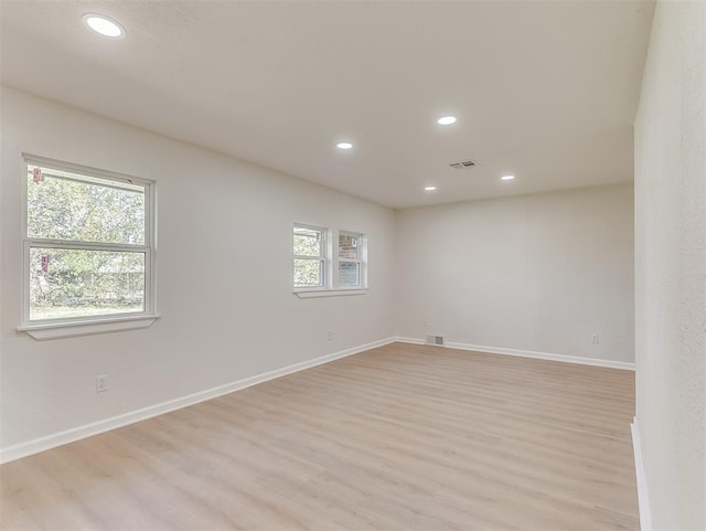 empty room with light hardwood / wood-style flooring