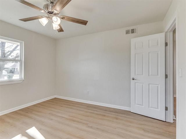 spare room featuring light wood-type flooring and ceiling fan