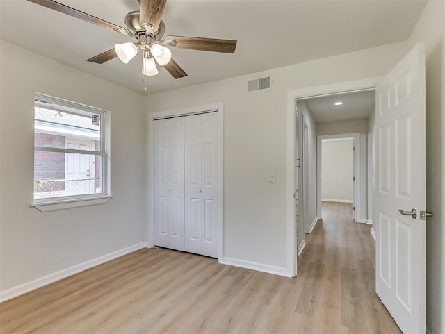 unfurnished bedroom with ceiling fan, a closet, and light hardwood / wood-style floors