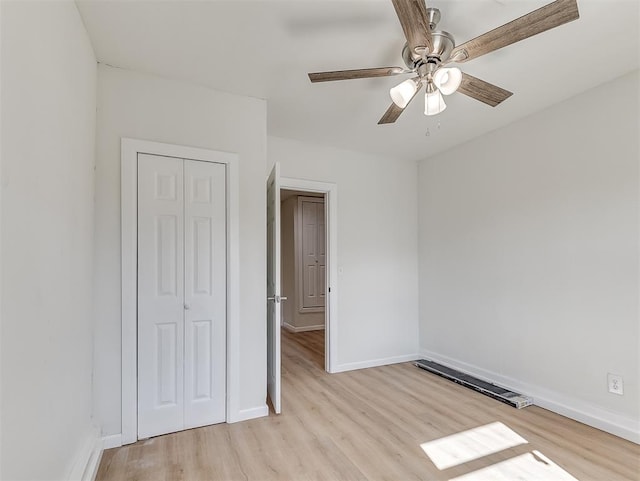 unfurnished bedroom with a closet, ceiling fan, and light hardwood / wood-style flooring