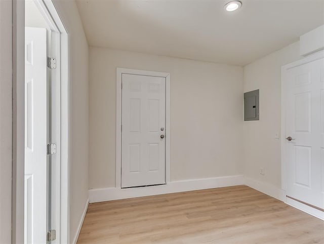 spare room with light wood-type flooring and electric panel