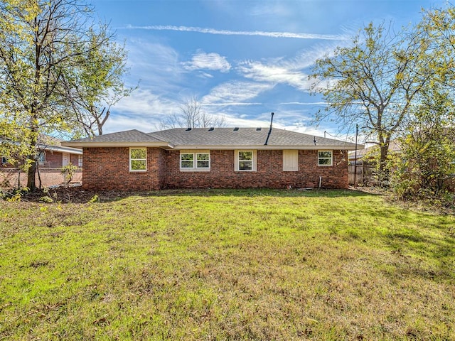 back of house with a lawn